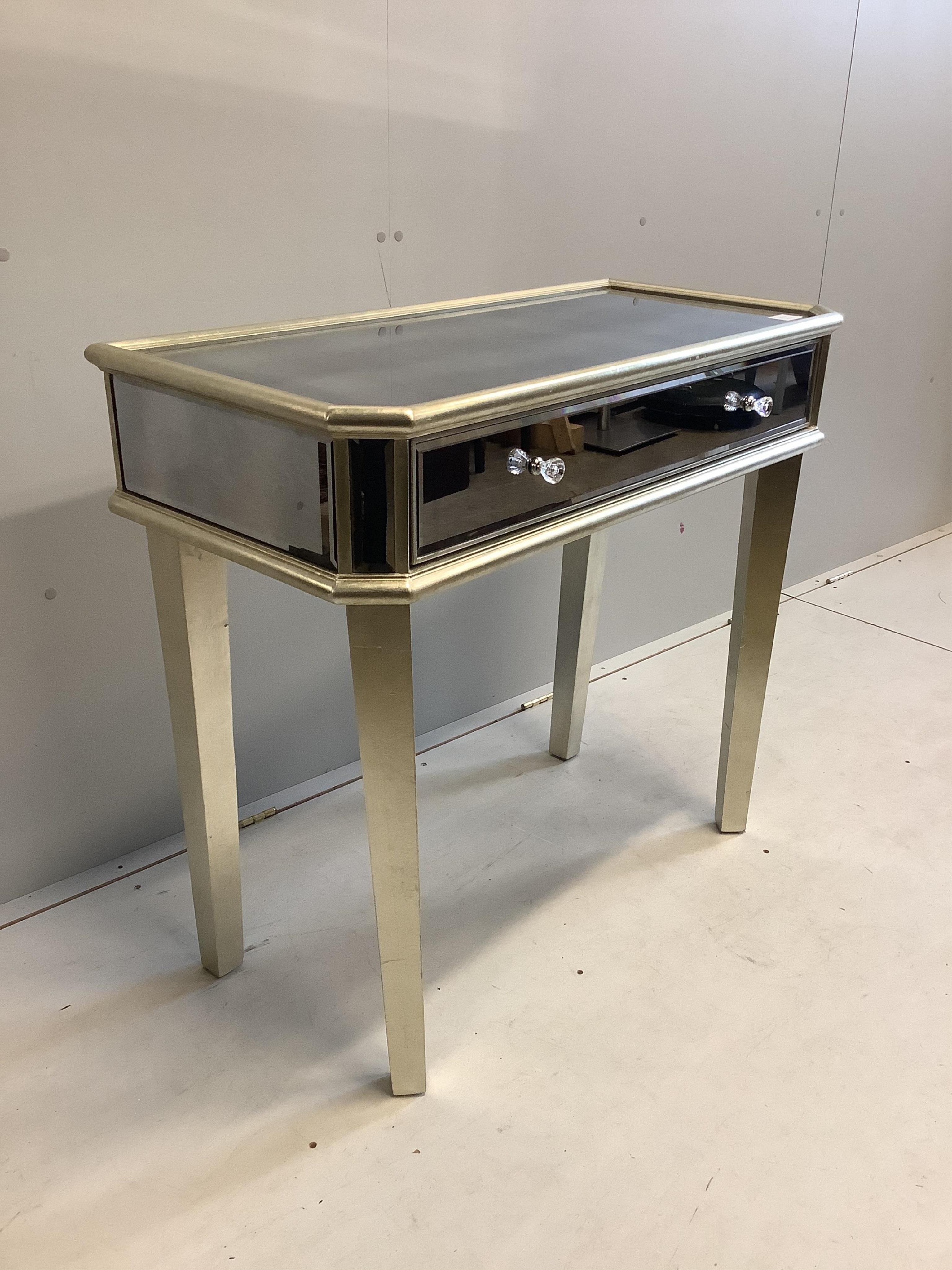 A Contemporary mirrored side table, width 92cm, depth 43cm, height 83cm. Condition - fair